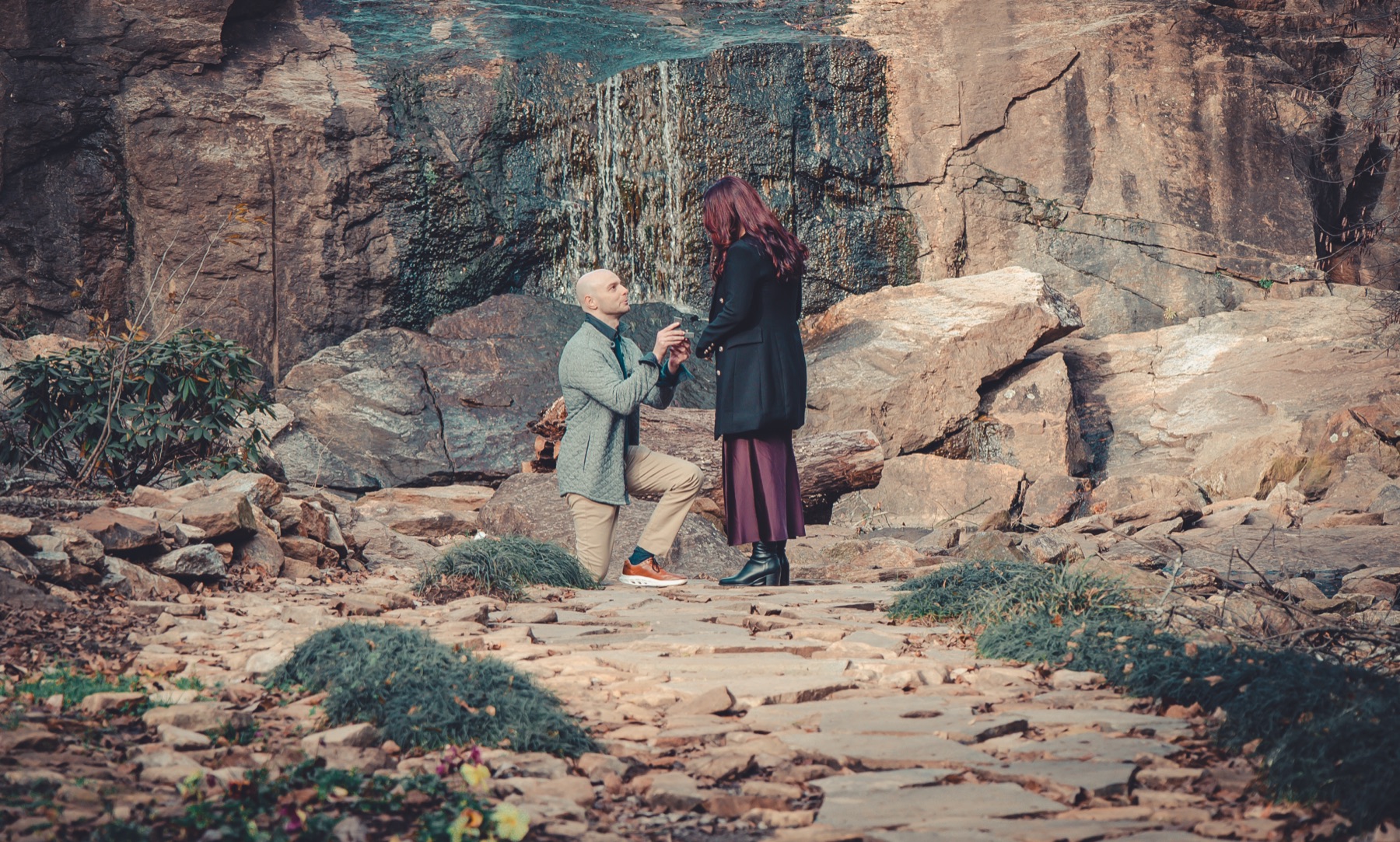 A proposal in front of the waterfall at the Rock Quarry Garden in Falls Park